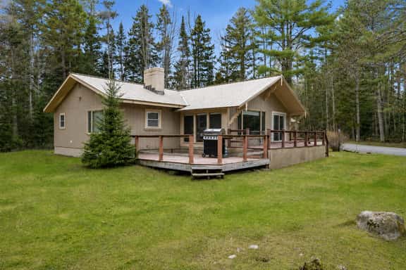 Private woodland cabin with wraparound deck and outdoor grill