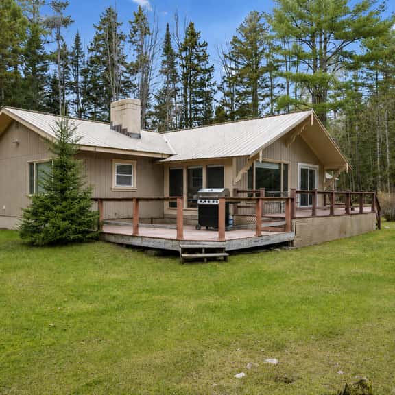 Private woodland cabin with wraparound deck and outdoor grill